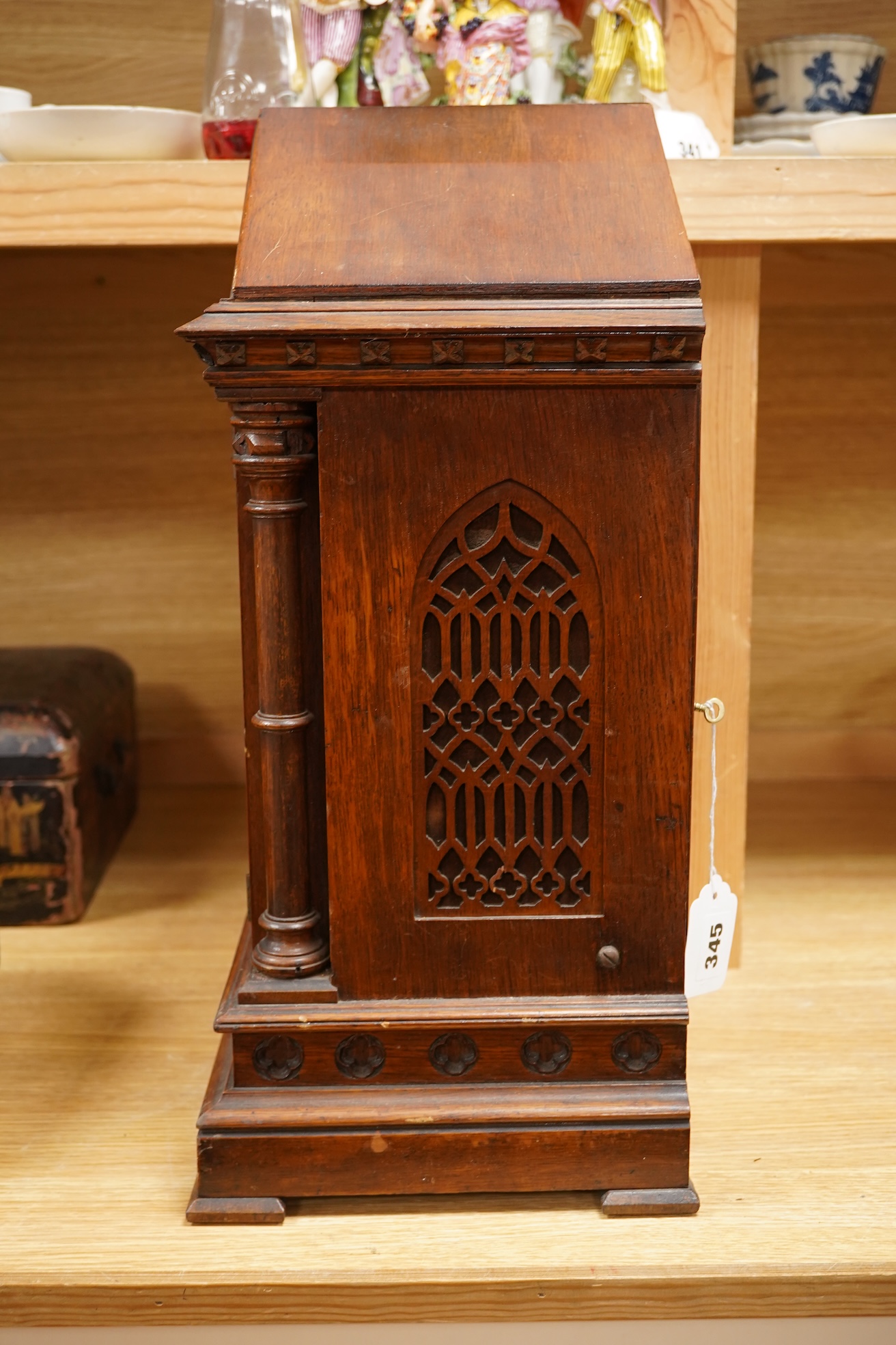 A German Gothic style oak mantel clock, early 20th century, with pendulum and keys, 49cm high